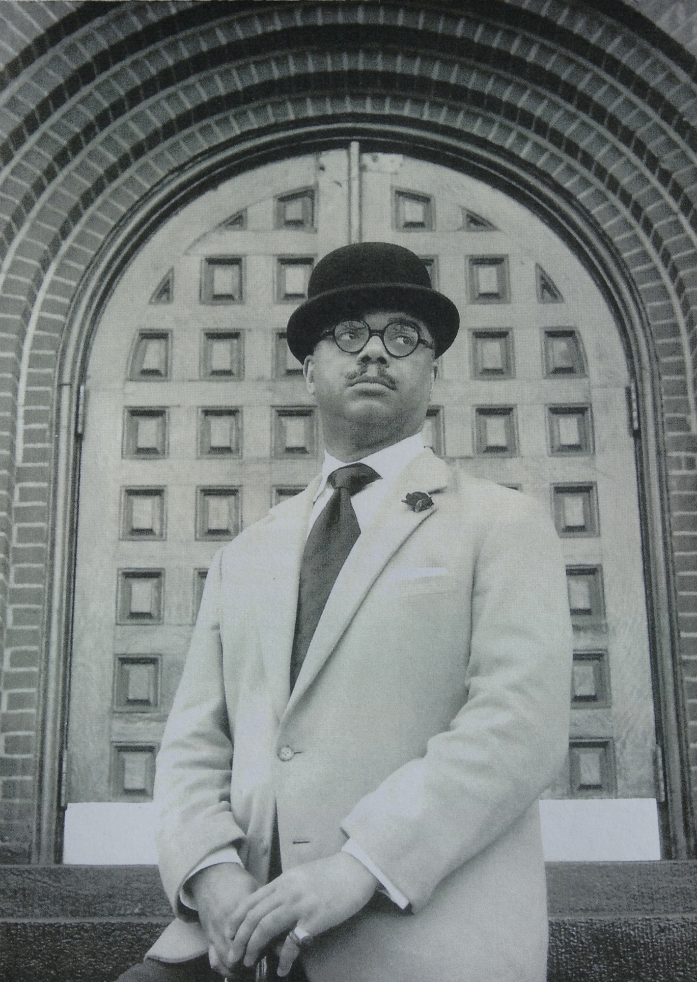 man in bowler hat with glasses and mustache